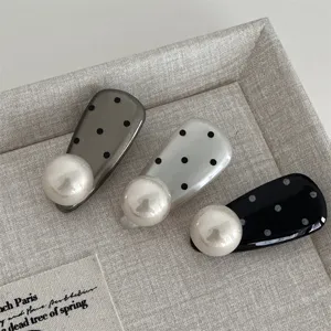 Charming polka dot pearl duckbill hair clip detail, sweet style side bang clip accessory.