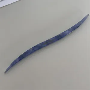 Blue marbled acetate hair stick detailed shot, elegant curved hair pin for chic bun styling.