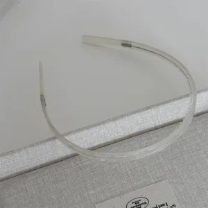Close-up detail of a minimalist transparent resin headband featuring subtle teeth for secure grip.