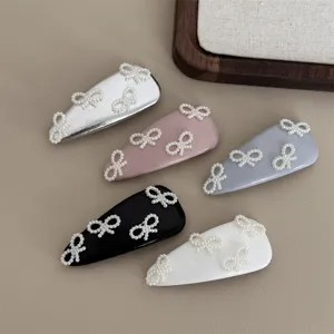 Ballet style leather pearl hair clip set, elegant bow side clip for bangs and fine hair styling.