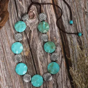 Retro ethnic style beaded necklace with turquoise faceted beads and silver metal charms.
