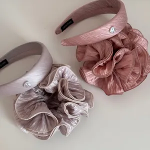 Detailed shot of handmade ruffled bubble gauze hairband and scrunchie set in pink.