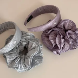 Pleated bubble yarn hair headband and scrunchie set detail view in elegant silver and purple.