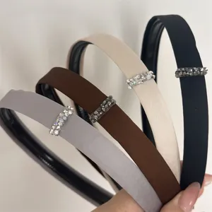 Detailed close-up of multi-color satin rhinestone headbands, elegant design with sparkling crystal.