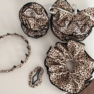 Leopardenmuster Haarschmuck Set mit grossen Haargummis und stilvollem Haarreif mit Zahnen.