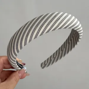 Detailed view of a chic black and white striped fabric headband, perfect for casual daily wear.