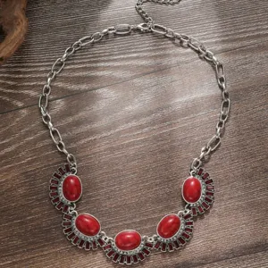 Close-up detail of vintage bohemian ethnic style red stone statement necklace silver chain.