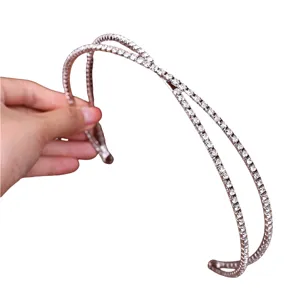 Close up of double strand rhinestone cross headband detail showing sparkling crystal stones.
