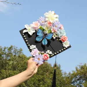 Close-up of decorated graduation cap featuring colorful artificial flowers and a blue butterfly.