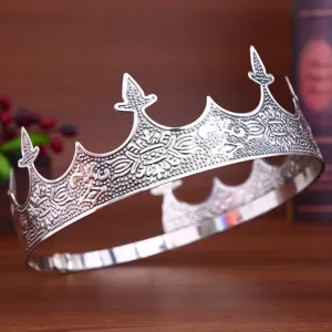 Detailed view of vintage silver men crown tiara, classic court style performance hair accessory.