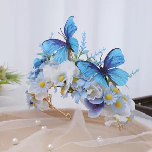 Close-up detail of blue butterfly silk flower hair crown, elegant floral headpiece for events.