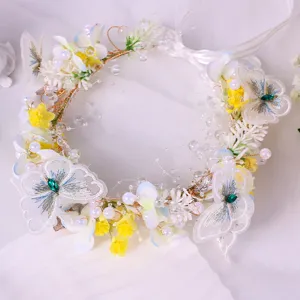 Detail view of the floral hair garland featuring delicate lace butterfly embroidery.