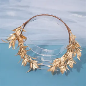 Detailed view of the golden leaf bridal headband, featuring delicate woven band and shiny leaves.
