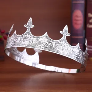 Retro silver metal crown headpiece for men, intricate embossed design, detail view.