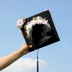 Floral graduation cap decorated with artificial flowers and black tassel for graduation party.