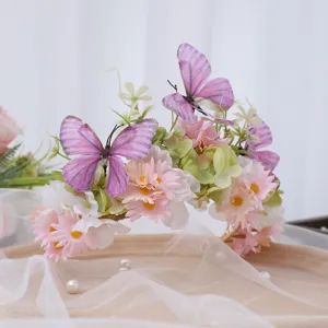Floral crown headband with artificial butterflies and pink silk flowers for photo shoot wear.