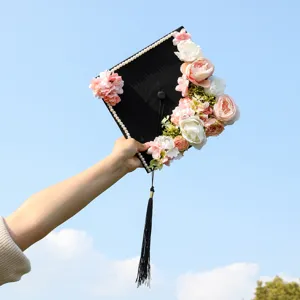 Detailed closeup of a beautifully decorated graduation cap with floral pearls and tassel.