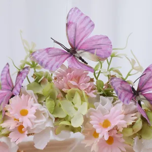 Detail of floral crown headband featuring pink silk flowers and purple butterflies for photo shoot.