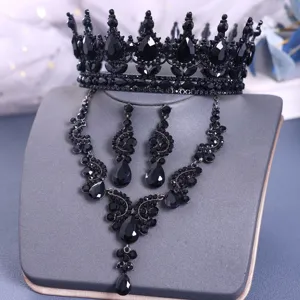 Detailed view of luxury black rhinestone bridal crown, necklace and earrings jewelry set.