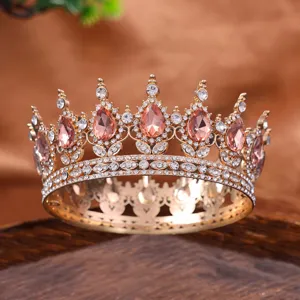 Close-up detail of a vintage gold full-circle tiara crown sparkling with pink and clear rhinestones.