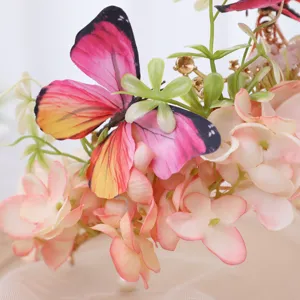 Luxury floral crown headband with butterfly and pink silk flowers for wedding photo shoots.