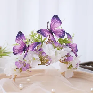 Detailed view of luxury baroque floral hair crown with purple butterflies and white silk flowers.