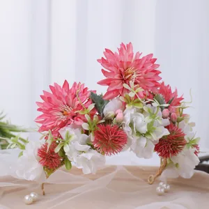 Close-up detail of the baroque floral hair crown adorned with pink flowers and pearls.