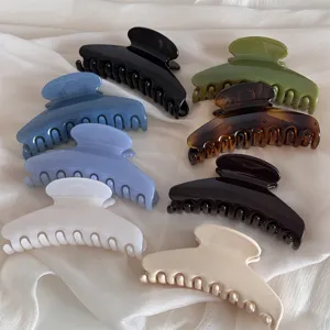 Detailed view of large hair claw clips in assorted jelly colors, stylish and elegant hair styling accessory.