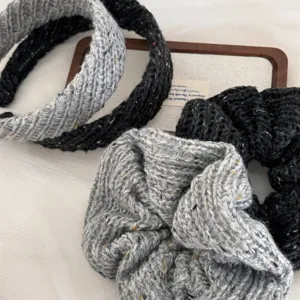Detailed close-up of chunky knit wool headband and scrunchie in black and grey style.