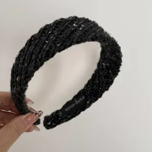 Detailed view of the black chunky knit tweed headband featuring a soft textured design.