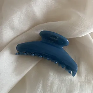 Blue jelly hair claw clip detail shot showcasing translucent resin material and strong metal spring.