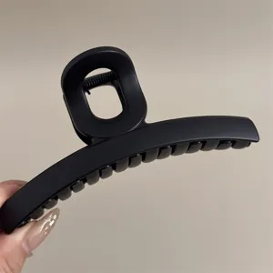 Gros plan détaillé d'une pince à cheveux noire mate élégante et tendance pour coiffure.
