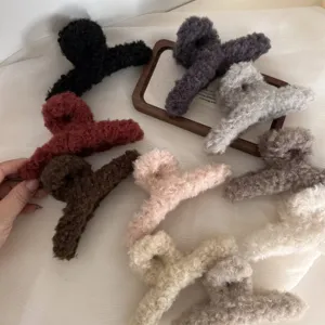 Fluffy winter hair claws in various colors, large plush shark clips for thick hair styling.