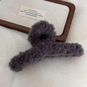 Fluffy dark grey hair claw clip detail, soft plush shark clip for thick hair, cozy winter hair accessory.
