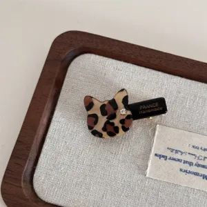 Close-up of cute leopard print cat acetate duckbill hair clip with sparkling rhinestone accent.