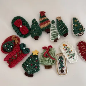 Close-up details of handmade Christmas crochet hair clips featuring cute trees and bows for kids.