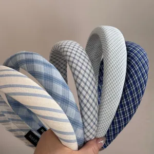 Close-up detail of blue and white plaid and striped fabric headbands showing texture.