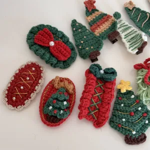 Detailed close-up of handmade crochet Christmas hair clips, featuring cute trees and bows.