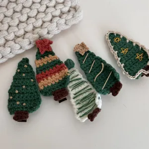 Handmade crochet Christmas tree hair clip detail view, cute winter hair accessory for kids.