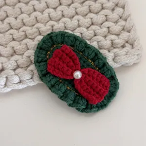 Handmade crochet Christmas hair clip with red bow and pearl for cute girls sweet side clip accessory.