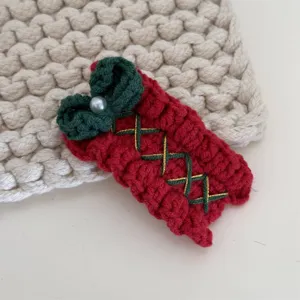 Handmade crochet Christmas hair clip with red knit design, pearl accent and cute bow.