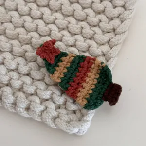 Detailed view of handmade crochet Christmas tree hair clip, vibrant yarn embroidery design.