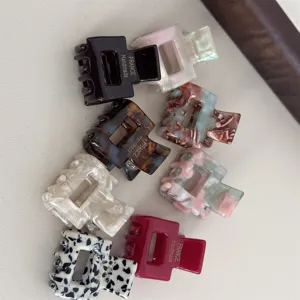 Mini acetate hair claw clips detail shot, showcasing various chic colors and patterns for daily styling.