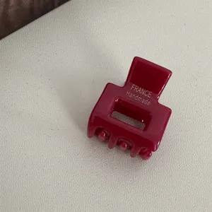 Detailed closeup view of a mini square acetate hair claw clip in a rich burgundy color.