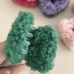 Close-up detail of fluffy plush hair claw in green, soft texture with secure teeth.