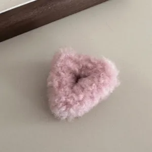 Pink fluffy hair claw clip detail shot, cute plush triangular design for sweet daily styles.