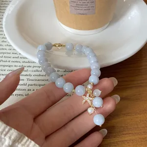 Close-up detail of a sweet blue chalcedony beaded bracelet with sparkling starfish pendant.