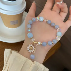 Charming blue chalcedony beaded bracelet featuring a sparkling zircon sunflower pendant and crystals.