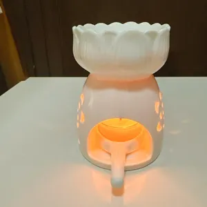 White ceramic lotus aroma oil burner candle lamp for home relaxation and desktop decor details.