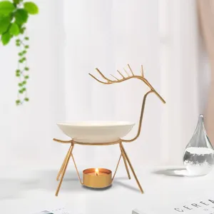 Gold iron reindeer aroma diffuser with ceramic bowl and candle holder for home spa decor.